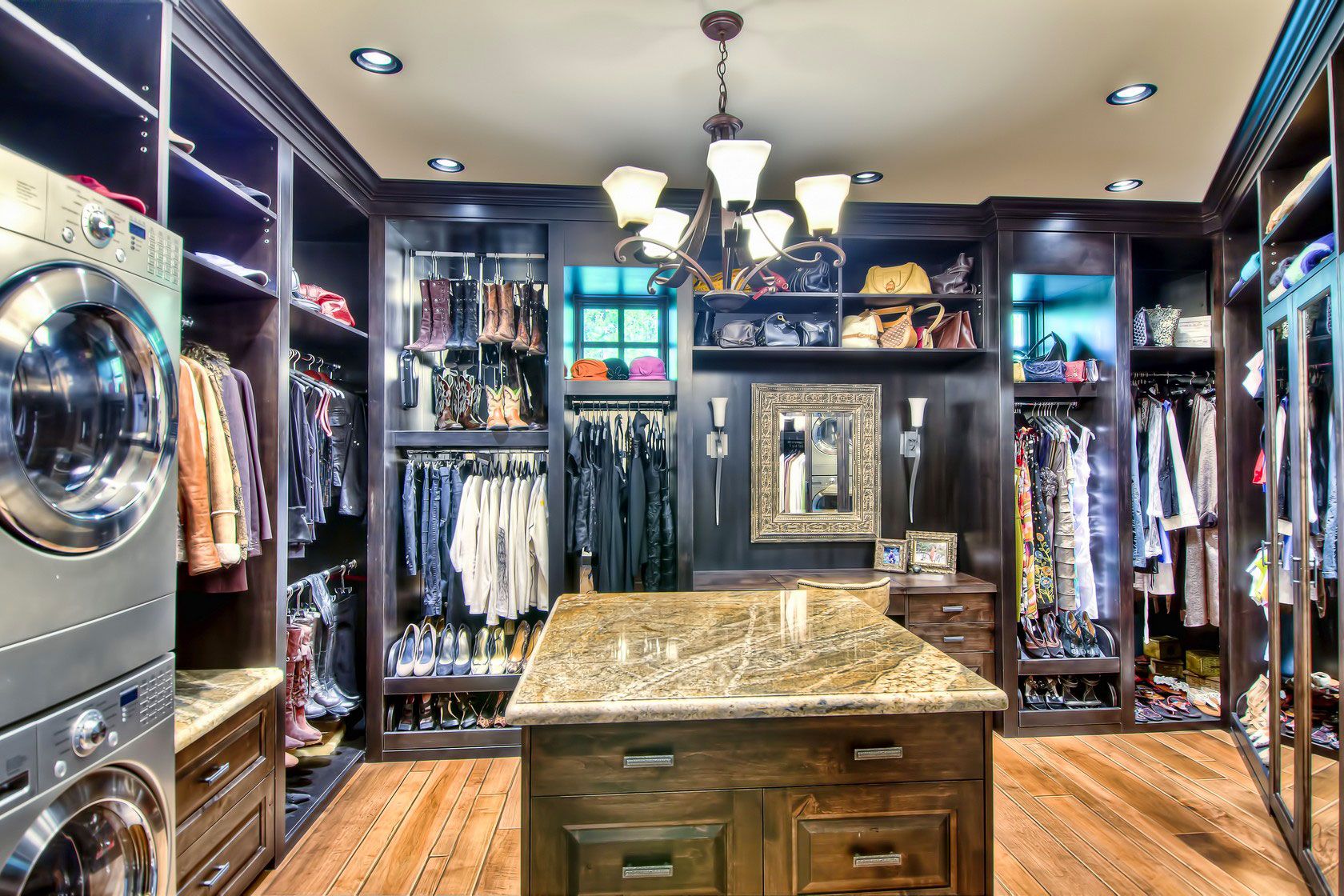 A walk-in closet with a granite-topped island